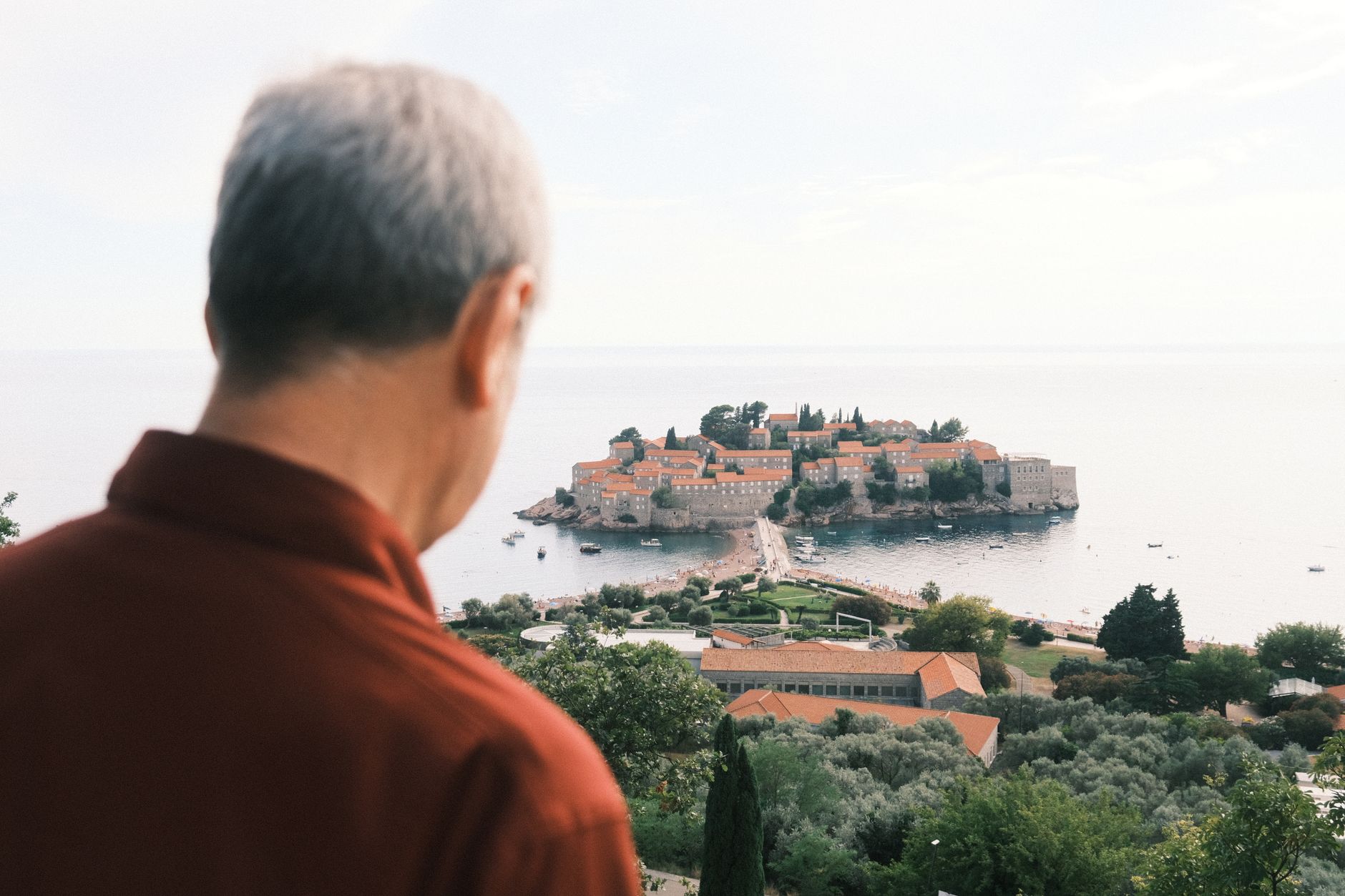 Solo traveler gazing at rolling Mediterranean landscape