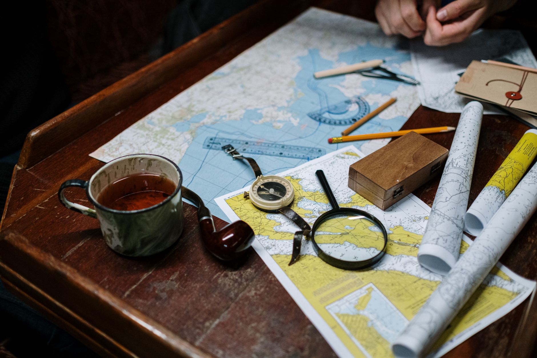 Travel desk with map, antique compass, and notebooks